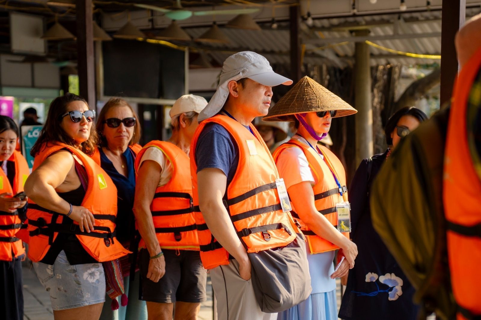 Du khách mặc áo phao trước khi xuống thuyền